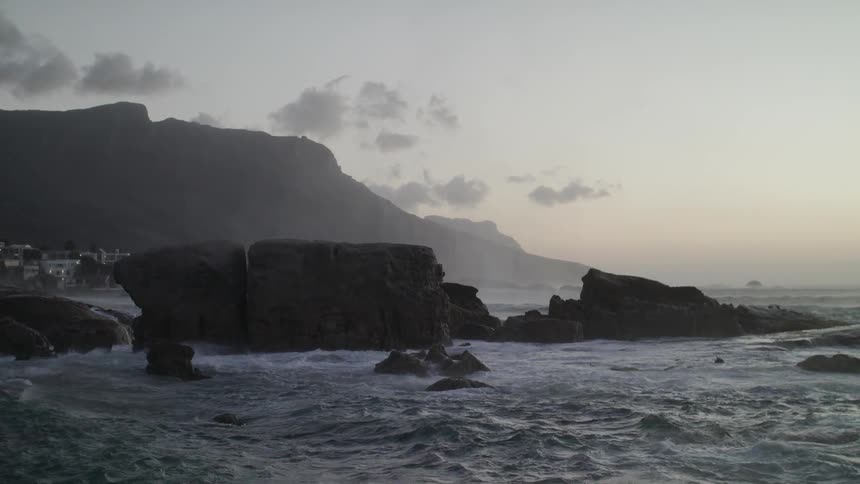 Waves crash into shore near the rocks
