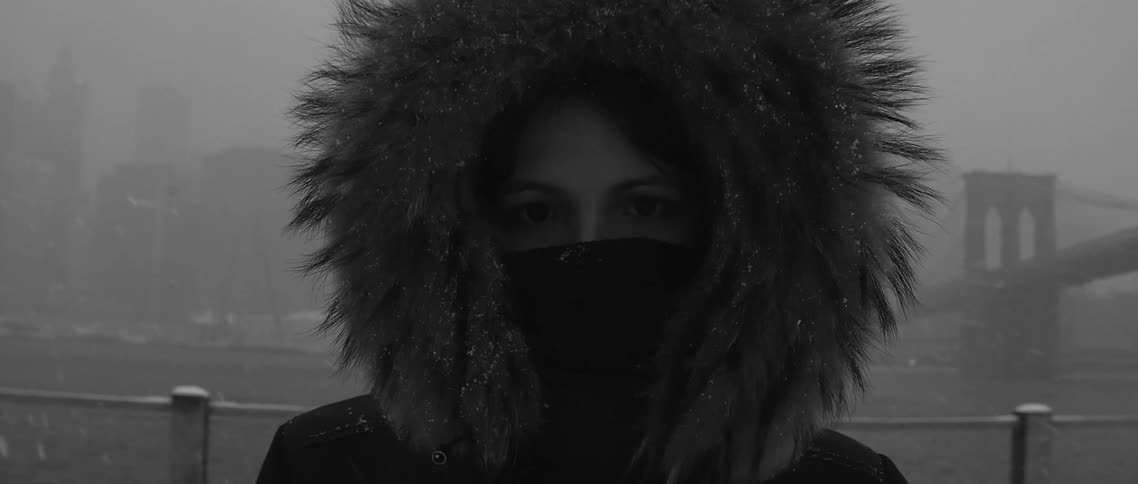 A person wearing a parka in the snow
