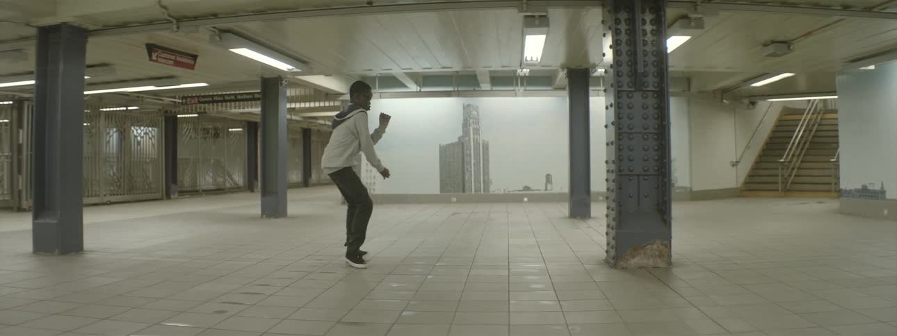 Boy dancing in a subway by himself