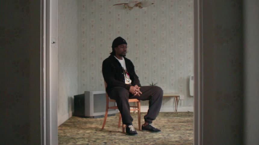Man sits on a chair in a living room