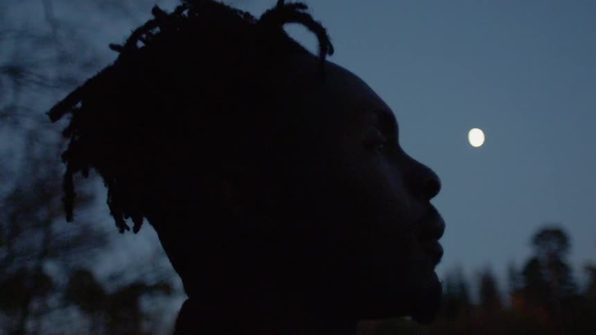 Man meditates under moonlight