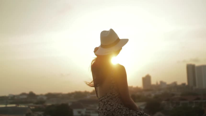 A person holding on to their hat