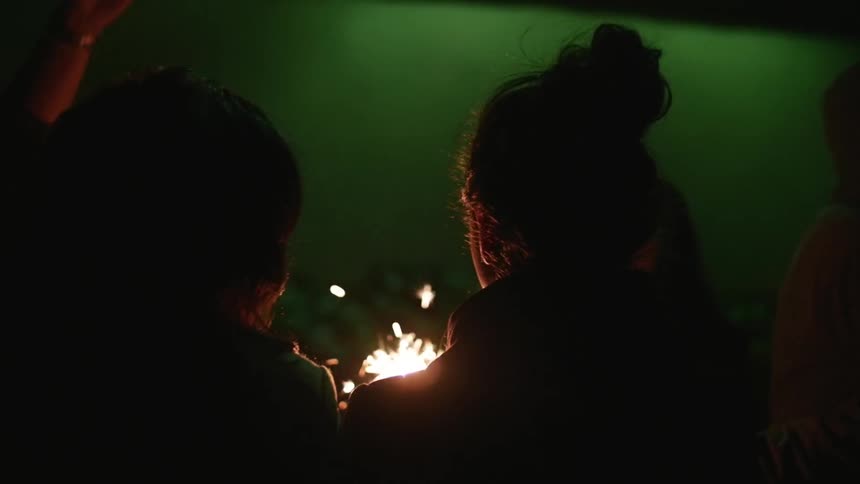 People holding sparklers