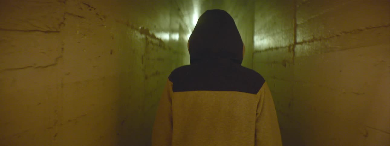 Person walks down towards a narrow hall