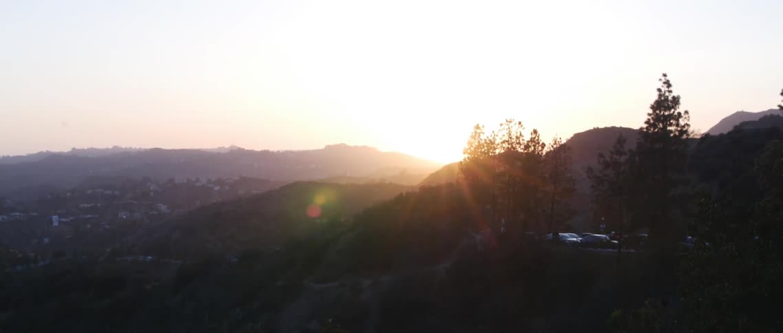 The sun setting over a hillside