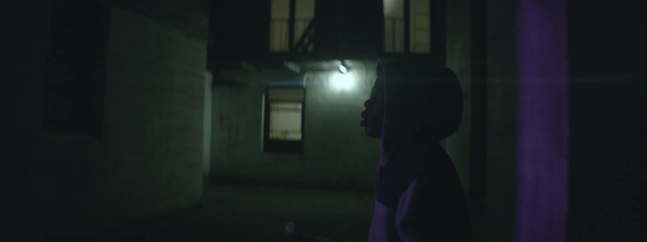 Man walking down a dark city street