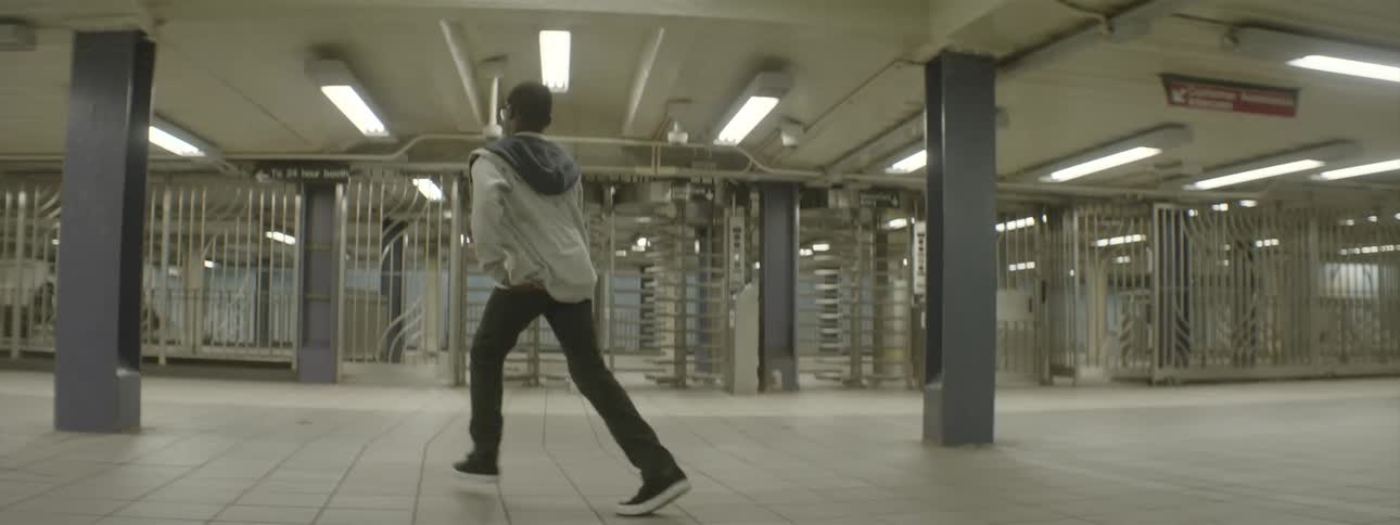 A boy dancing in an underground structure