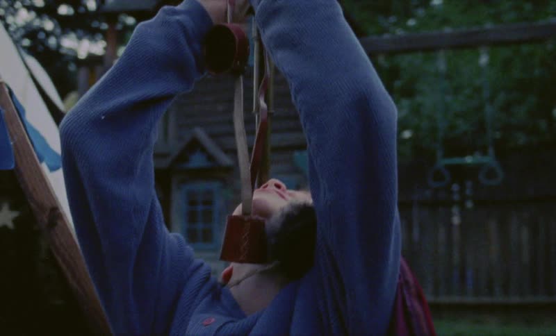 Boy plays with toys in a backyard