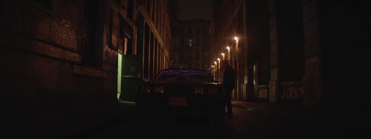 Men exit a building at night