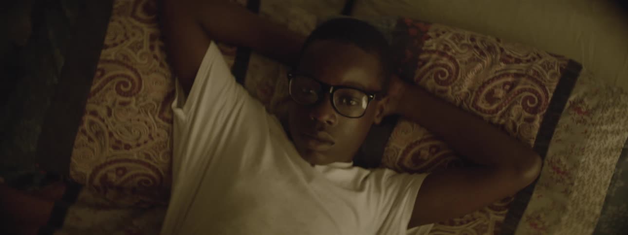 Man laying on a bed gets up