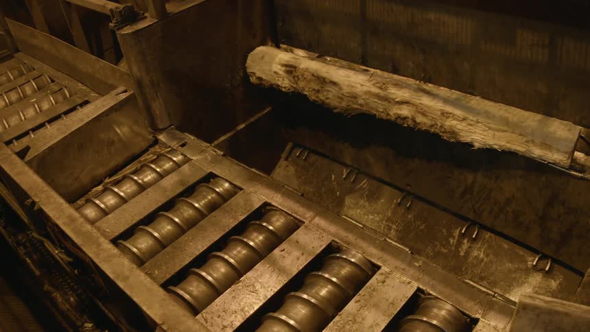 Machines rotate and spin in a dimly lit factory