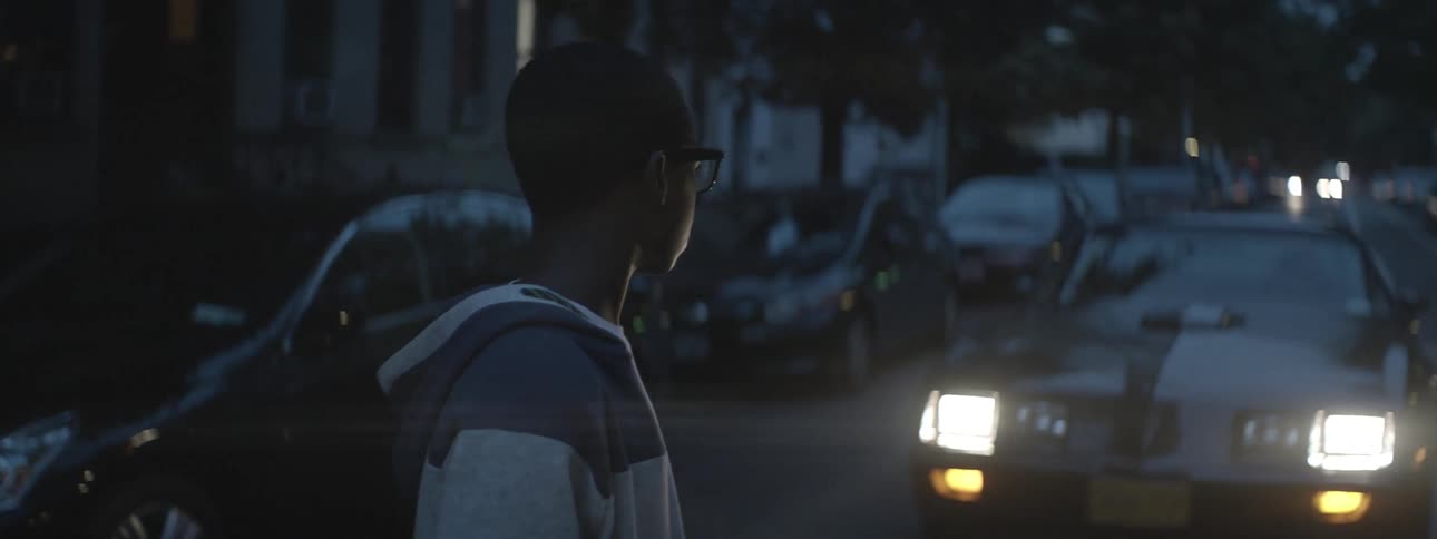 Man looking down the street at night