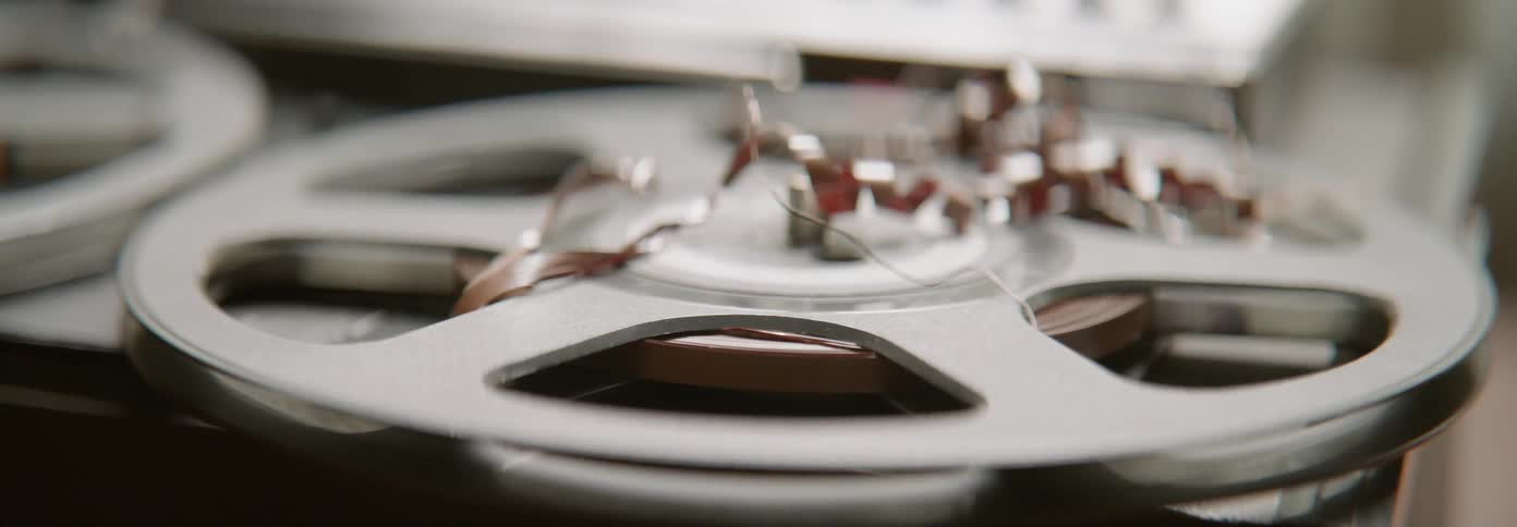 Film ribbons are strewn across the film reel