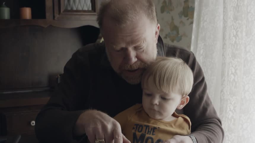 A man reads to a young child