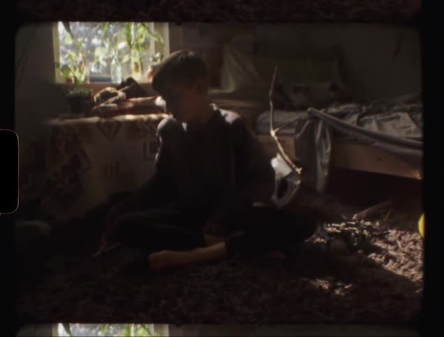 Child plays in a messy bedroom