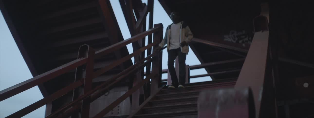 Teen boy descends an outdoor staircase