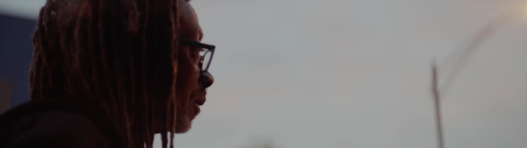 Woman looking outside at sunset