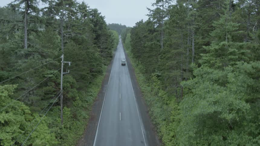 Car drives down a country road