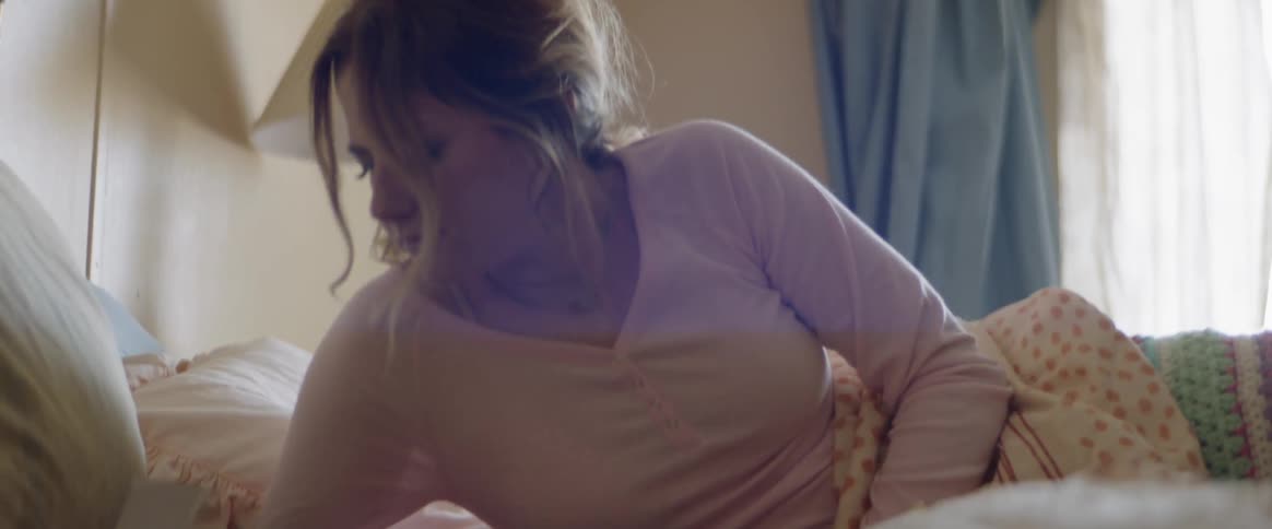 Woman laying in bed in a hotel room