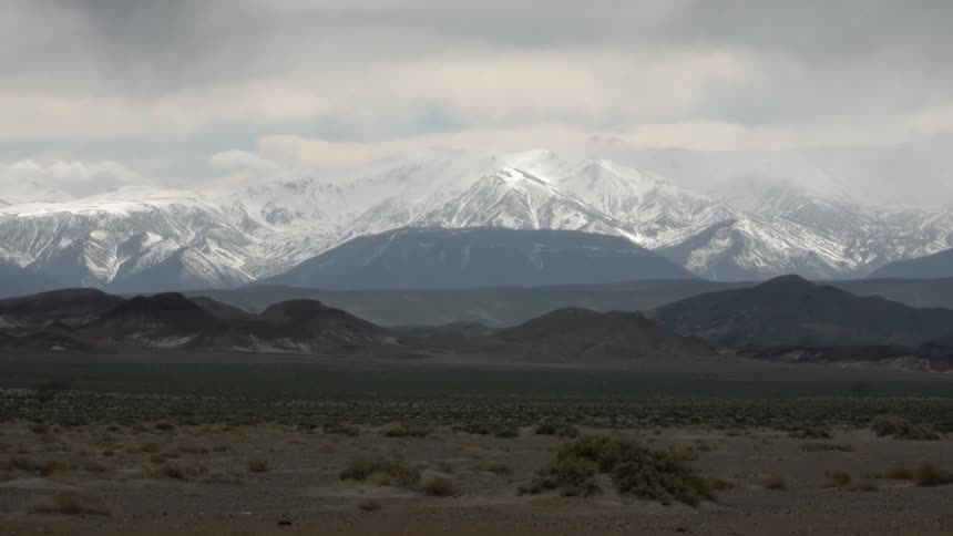 Snow covered mountains under a cloudy sky