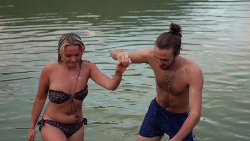 Man pulls a woman up out of the water