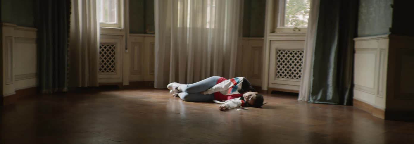 Woman lies on a wood floor