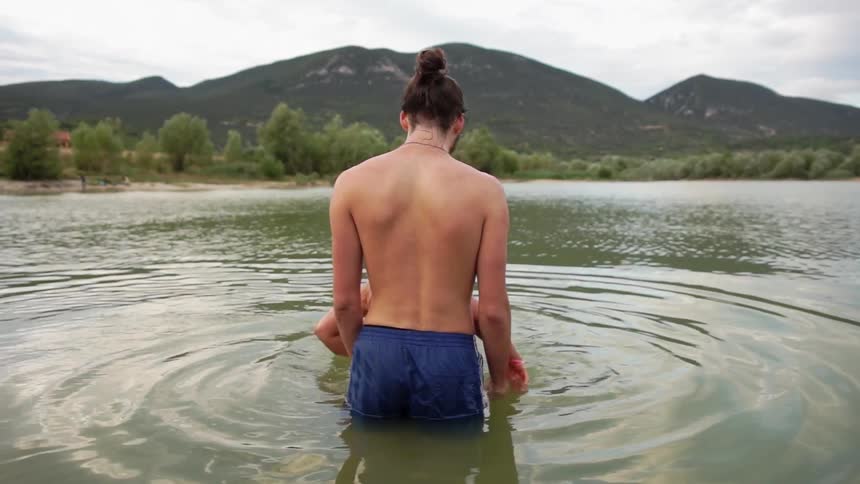 Man stands in a shallow lake