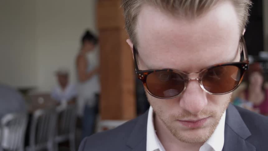 Man wearing sunglasses looking down