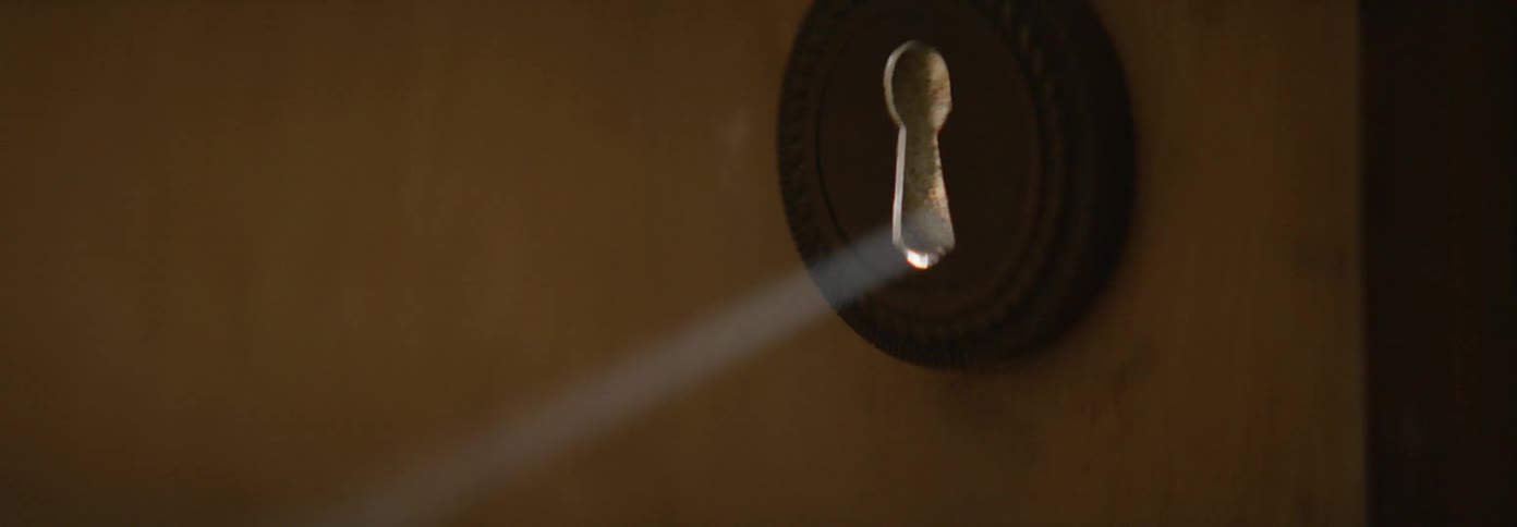 Sunlight shines through a keyhole