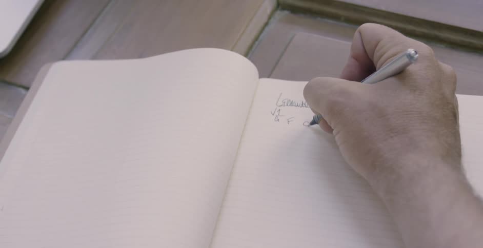 Man writes in a notebook