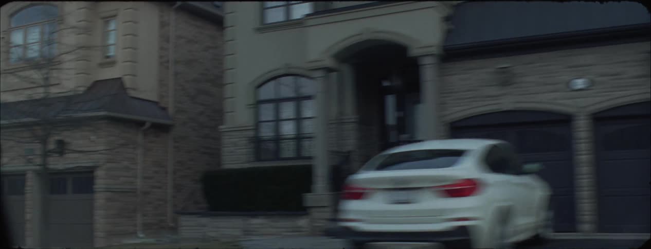 Homes in a neighborhood with cars parked in driveways