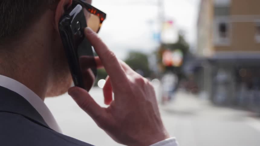 Man holds a cell phone up to his ear