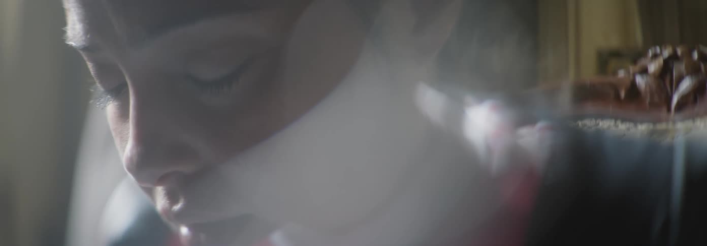 A woman speaks softly and closes her eyes