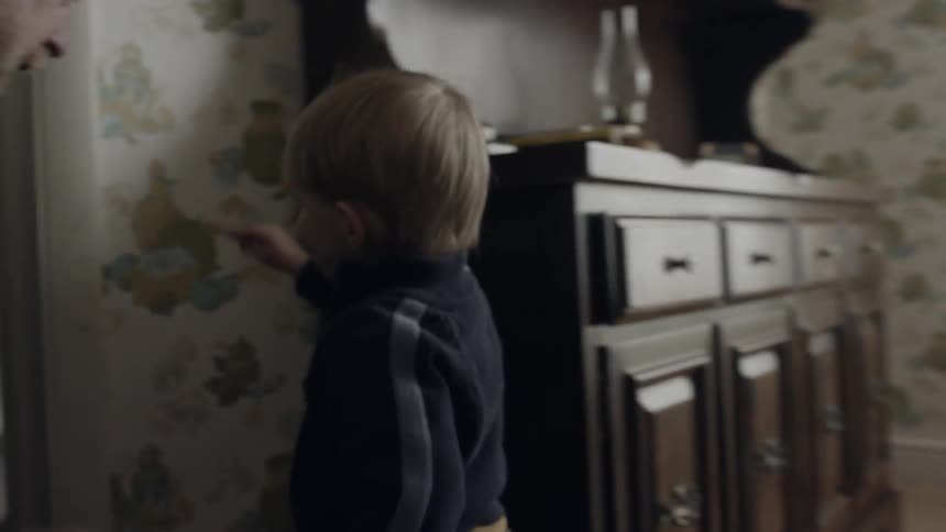 Toddler marks height on door frame