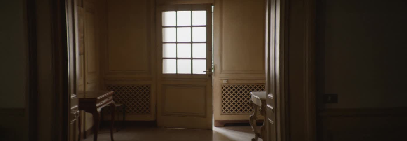 An empty room with a door slightly ajar