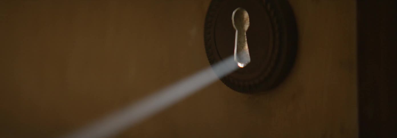 Sunlight shines through a keyhole