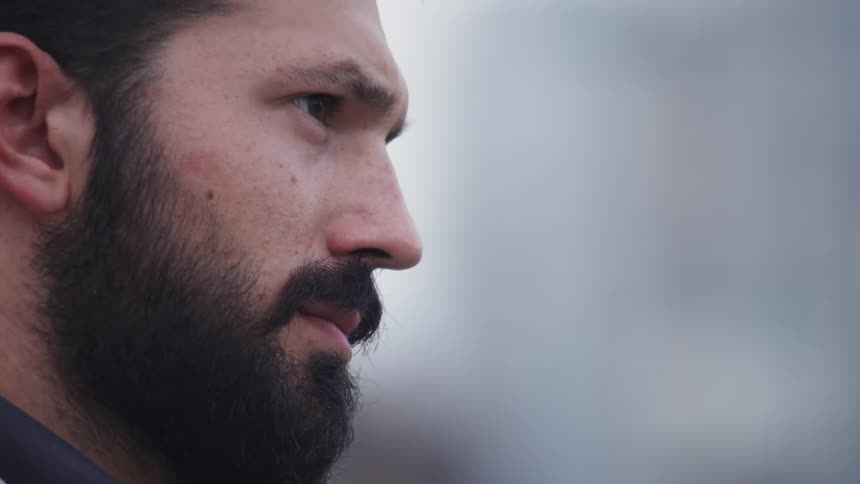 A man with a beard looks concerned