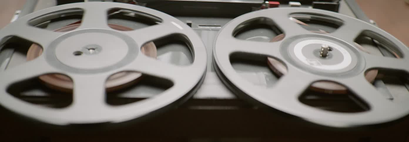 A reel to reel machine spins