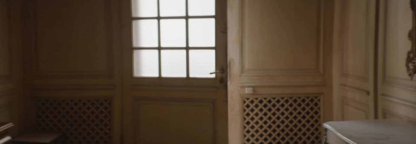 A door is standing ajar inside a home during the day