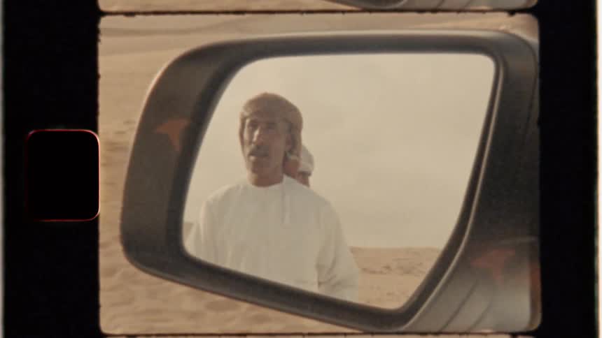Men in car side mirror