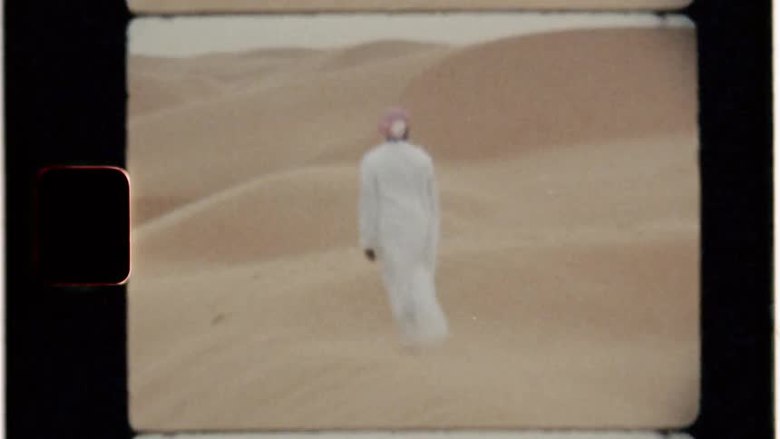 Wind blows around a man in a sandy desert