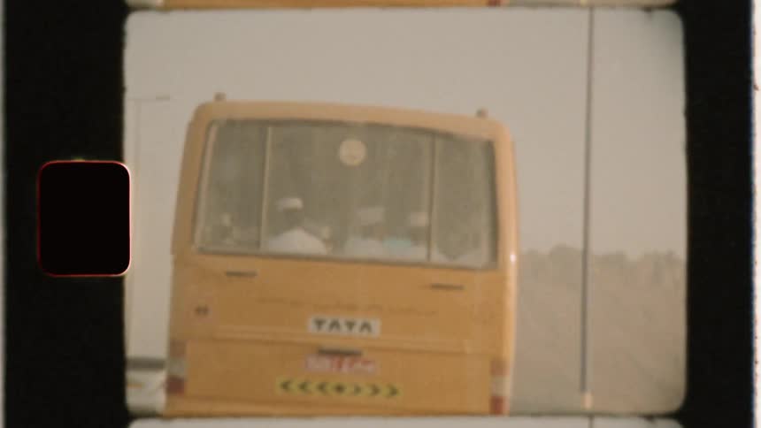 Bus travels down the highway under a cloudy sky
