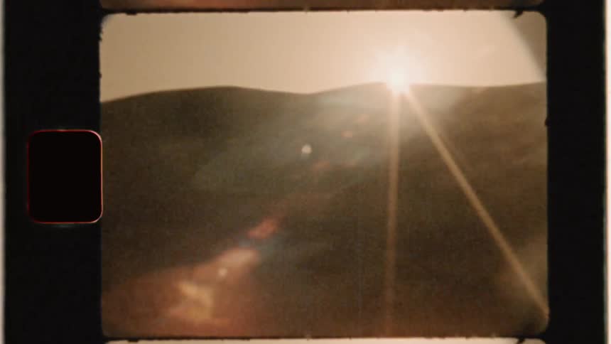 The sun sets over a mountain