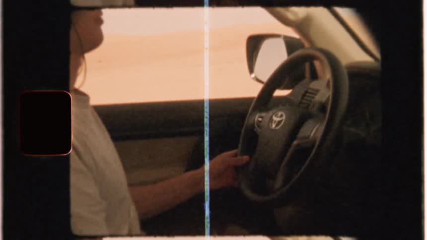 A man drives in the desert