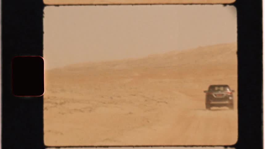 Car drives across desert