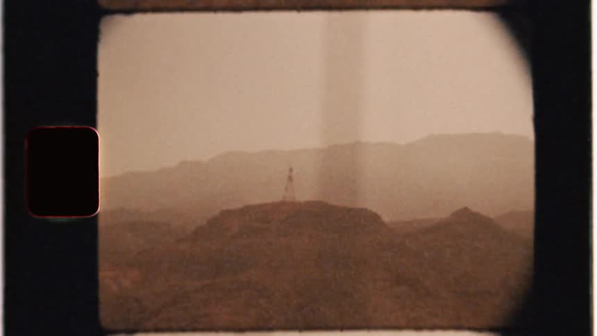 A radio tower stands tall from atop the hill