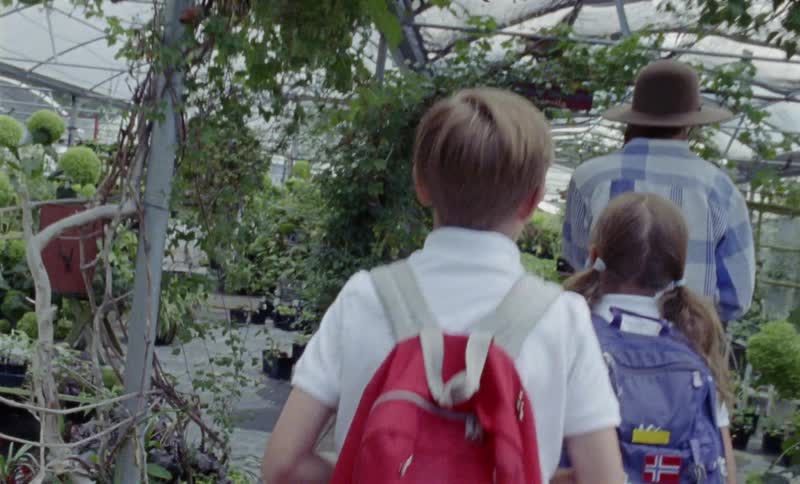 School children walk through a greenhouse