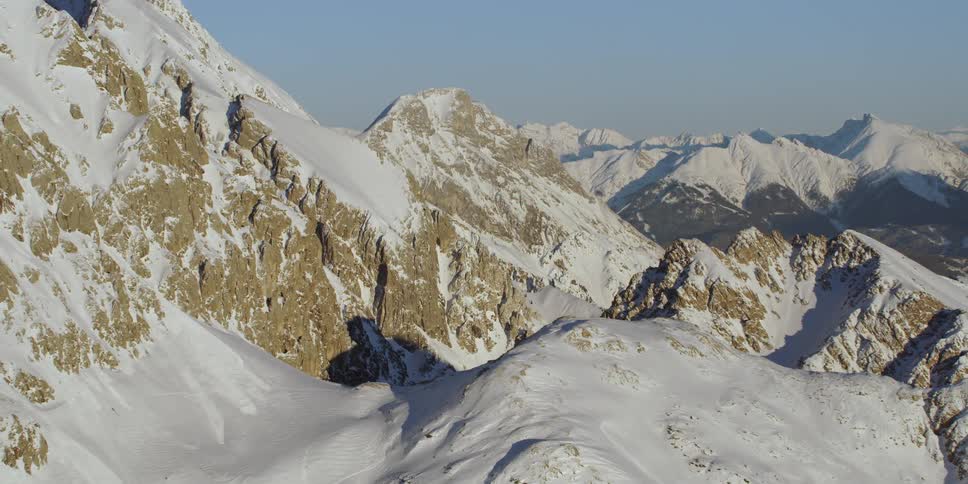 Snow covers rocky mountain peaks