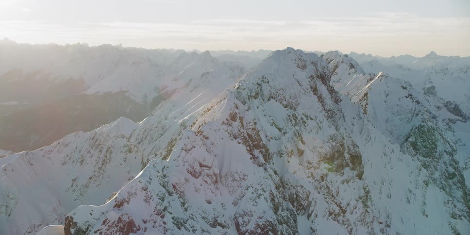 Snow covered mountains under a cloudy sky