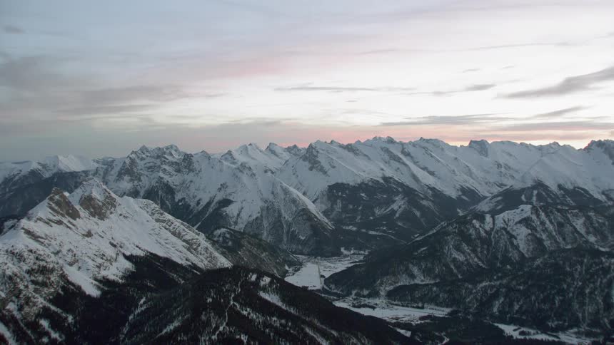 Snow covered mountains under a cloudy sky